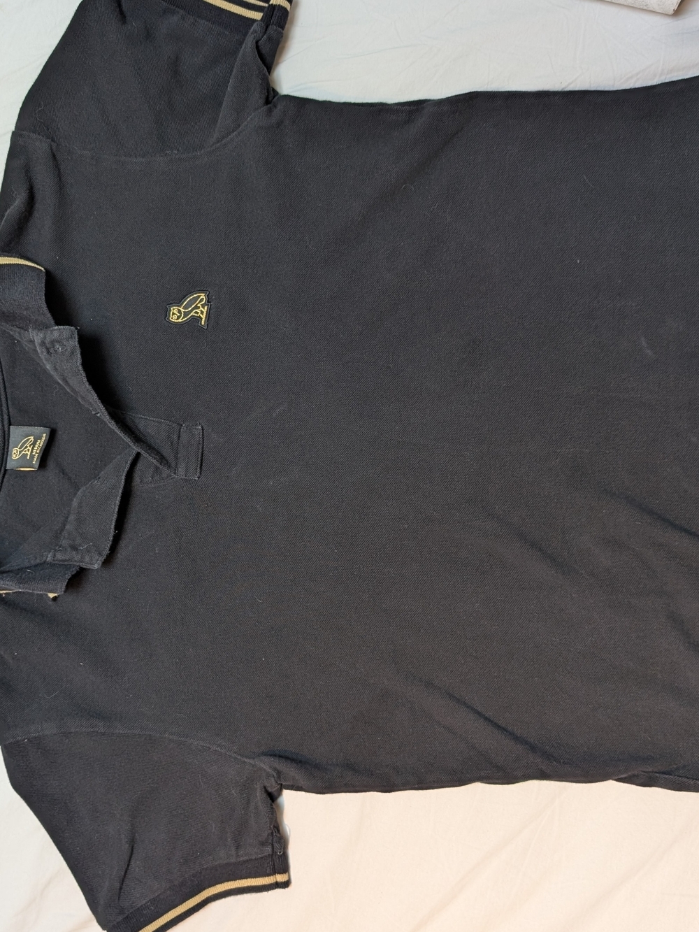 Men's OVO Drake Black Polo Shirt with gold accents.